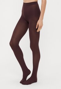 Burgundské neprůhledné punčocháče s hladkou texturou, elastickým pasem a celoplošným střihem. Ideální pro vrstvení nebo běžné nošení.