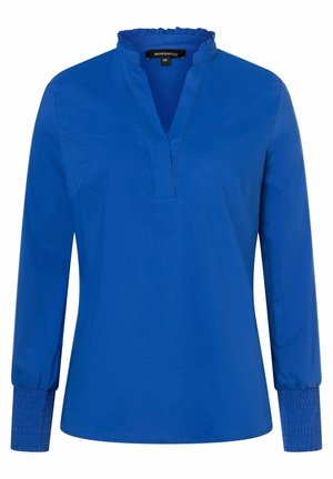 Blouse bleue à manches longues avec col à volants, profond décolleté en V et poignets smockés, taille 38, marque More & More.
