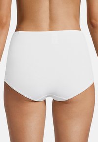 Woman wearing plain white high-waist cotton underwear, shown from the back, against a plain white background.