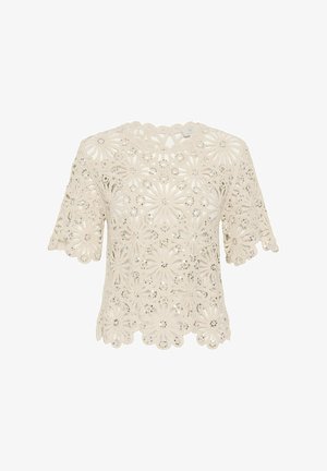 Blusa corta de encaje crema con manga corta, patrón floral recortado y pequeños adornos de lentejuelas, borde festoneado en el dobladillo y las mangas.