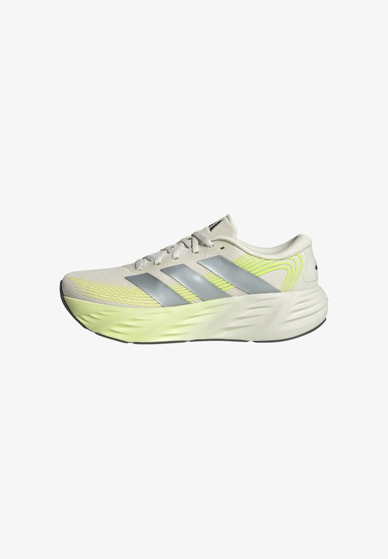 Light beige Adidas running shoe with silver stripes, neon yellow accents, cushioned sole, and lace-up closure, shown from the side.