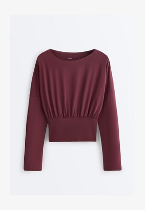 Dlhý rukáv, bordový krátky top so sťahovaním v páse a širokým okrúhlym výstrihom, vyrobený z mäkkej elastickej látky.