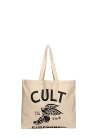 Beżowa torba płócienna z wyraźnym czarnym napisem "CULT" oraz grafiką skrzydlatej buty. Solidny materiał i długie rączki do łatwego noszenia.