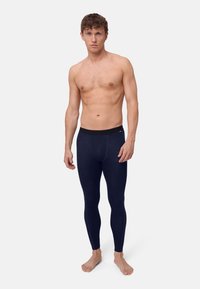 Dunkelblaue, eng anliegende Thermoleggings mit einem schwarzen elastischen Taillenbund, glatter Textur und Nahtverlauf an den Seiten.