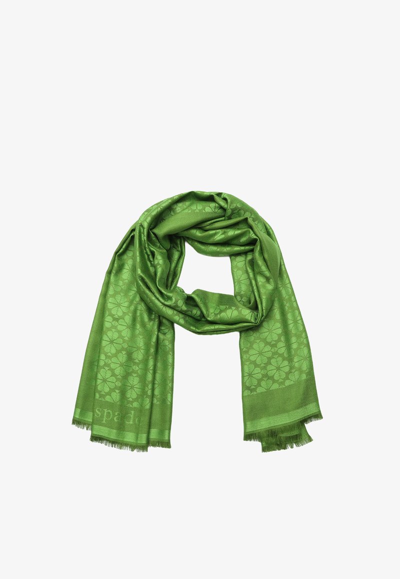 Green silk scarf with floral pattern, soft texture, and frayed edges, wrapped elegantly in a loop shape.