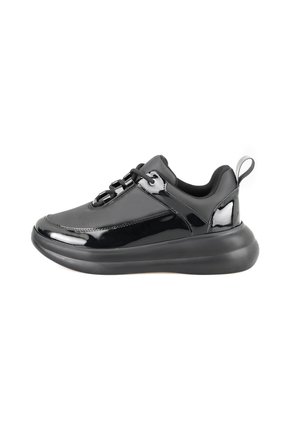 Black athletic sneakers with a glossy finish, rounded toe, padded collar, and lace-up closure. Features a thick, textured sole and pull tab.