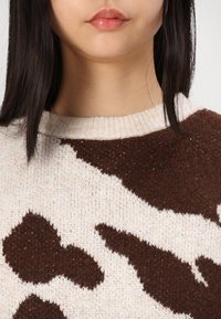 Maglia a collo alto in lana merino Beige | Donna - GAP Italia