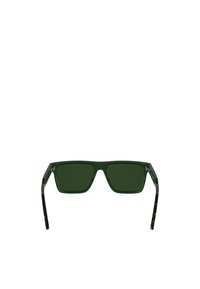 Ochelari de soare verzi cu lentile pătrate, o ramă groasă transparentă și brațe cu un design pattern ce include accente în nuanța țestoasei întunecate.