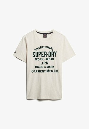Light beige cotton t-shirt with short sleeves, featuring green bold text: "TRADITIONAL SUPER-DRY WORK-WEAR J.P.N TRADE 26 MARK GARMENT MFG. CO."