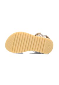Chaussures avec une semelle en caoutchouc texturé, de couleur beige clair, et de multiples rainures pour une meilleure adhérence. La tige présente un motif.