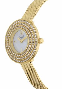 Uhr mit goldfarbenem Milanaise-Armband und rundem Gehäuse, ausgestattet mit weißem Zifferblatt und umgeben von konzentrischen Ringen aus klaren Kristallen.