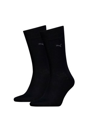Chaussettes noires en coton avec une texture côtelée, comportant un petit logo gris. Longueur mi-mollet avec une finition lisse et sans motifs.