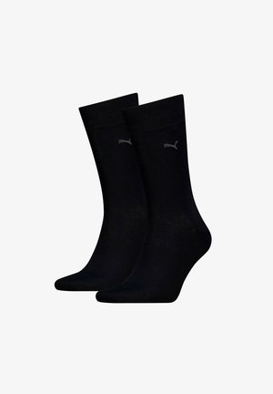 Black cotton socks with a ribbed texture, featuring a small gray logo. Mid-calf length with a smooth finish and no patterns.