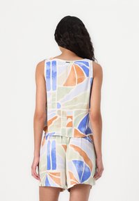 Multicolored sleeveless top with abstract patterns in blue, orange, and green, made of lightweight fabric, paired with matching shorts.