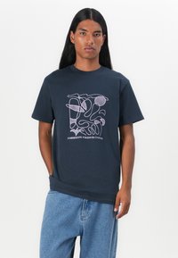 Navy cotton t-shirt featuring a graphic design with abstract shapes in light pink and the text "FREEDOM FROM CHAOS." Short sleeves and crew neck.