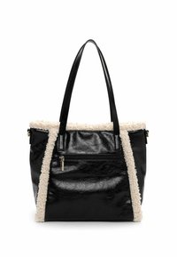 Black faux leather tote bag with cream fur trim, two sturdy handles, a front zip pocket, and a glossy finish. Textured surface details present.