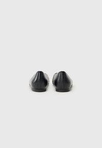Schwarze Leder-Ballerinas mit glatter Textur, runder Zehenpartie und minimalistischem Design. Verfügen über eine flache Sohle und eine rückseitige Nähte.