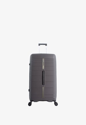 Hard-shell gray suitcase with horizontal ridges, silver accents, retractable handle, and four wheels for mobility.