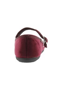 Zapato de tejido burdeos con suela plana, correa ajustable y suela de goma texturizada para mayor agarre. Superficie lisa y diseño sencillo.