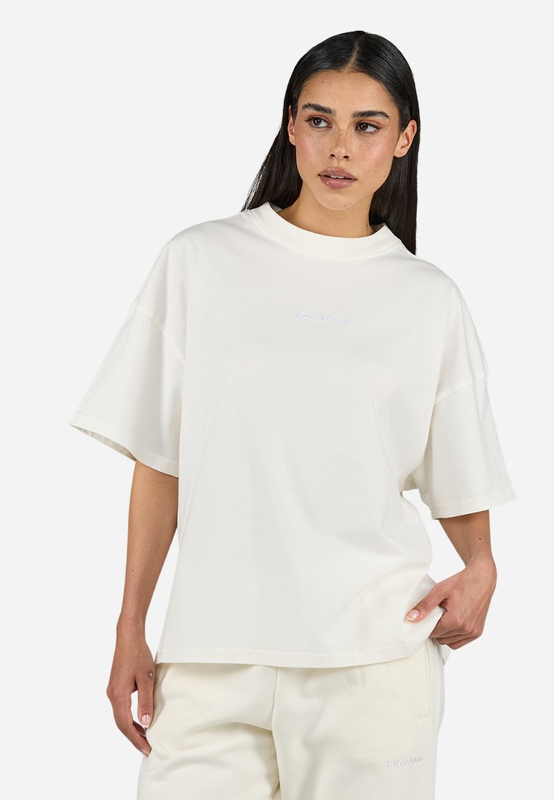 Oversized white cotton t-shirt featuring a crew neckline, short sleeves, and subtle embroidered logo in the center. Smooth texture.