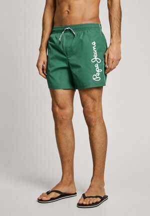 Zelene kopalne hlače z elastičnim pasom, vrvico in belim logotipom "Pepe Jeans" na strani. Narejene so iz lahkega, gladkega blaga.
