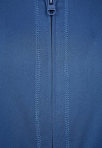 Blue zip-up garment with a smooth, stretchy texture. Features a central zipper and reinforced stitching along the seams.