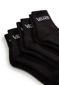 Sorte bomuldsstrømper i en stablet ordning. Ribbet manchetter med hvid "VANS" logo. Glat tekstur og ankellængde design.