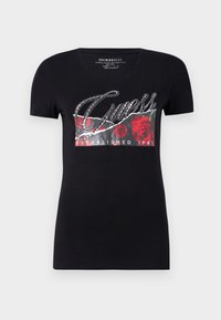 Black t-shirt featuring a front graphic with red roses, silver accents, and the text "Guess Established 1981" in a cursive font. Short sleeves.