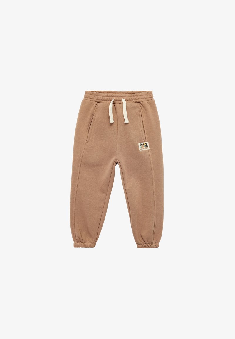 Pantaloni jogger color beige realizzati in morbido tessuto, con vita elastica e coulisse, tasche laterali e polsini elastici alla caviglia.