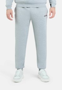 Grijze sweatpants van zacht materiaal, met een elastische taille, slim fit, zijzakken en een klein logo op de linker dij.