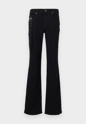 Black flared jeans featuring a textured fabric with a subtle pattern, silver hardware, and front pockets. Zipper detail on the side.