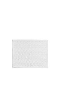 Tapis de bain en coton blanc avec un motif à côtes texturé et des bords tissés, de forme rectangulaire et avec une surface douce. Dimensions non spécifiées.