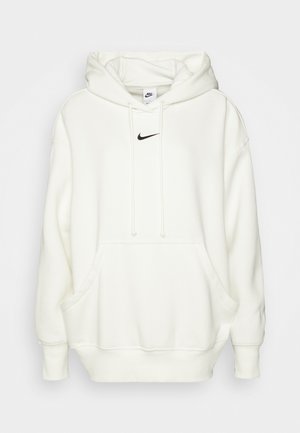 Balta striukė su kapišonu, juodas Nike logotipas krūtinėje, priekiniame kengūros kišenė ir tinkliniai rankogaliai bei apatinis kraštas. Minkšta, lygi tekstūra.
