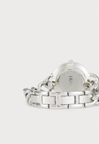 Silver stainless steel watch with a bold chain link bracelet and a round case. Back features engraved details, including water resistance information.