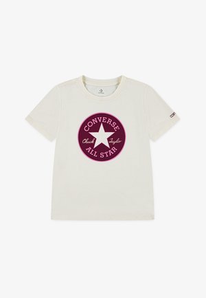 Cream-colored cotton t-shirt featuring a circular maroon logo with a white star and "Converse" and "Chuck Taylor" text. Short sleeves.