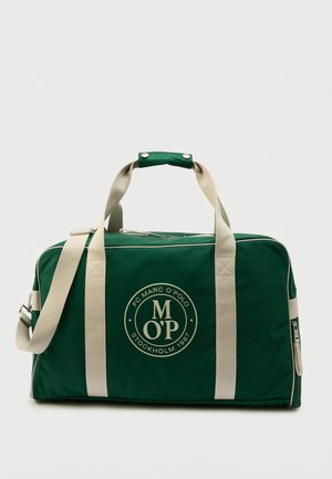 Roheline põrandakott beežide rihmadega, tõmblukuga ja esiküljel ümmargune logo, millel on kiri "Marc O'Polo Stockholm 1967".