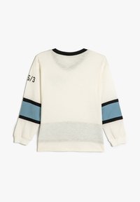 Weißes Langarm-Sweatshirt mit schwarzem Kragen und Bündchen, mit blauen Streifen an den Ärmeln und auf dem linken Ärmel aufgedrucktem Text.