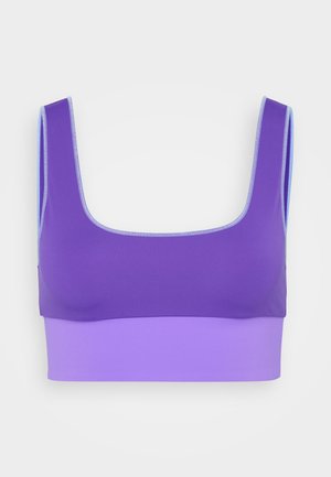 Purple sports bra with wide straps and a lighter purple elastic band at the bottom, displayed against a white background.