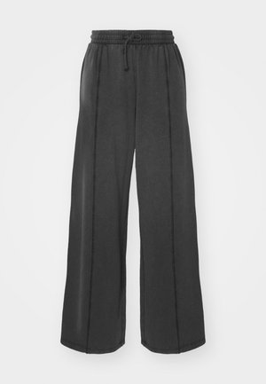 Pantaloni neri a gamba larga realizzati in tessuto morbido con vita elastica e cordoncino. Presentano cuciture a contrasto lungo le cuciture laterali.