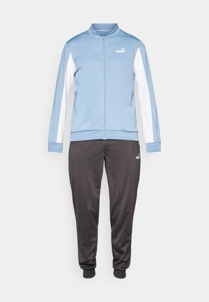 Ljusblå och vit zip-up jacka som matchas med svarta smalrandiga joggerbyxor, båda med Puma-loggor.