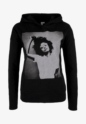 Felpa nera con cappuccio con una foto in bianco e nero di una persona con capelli ricci, occhiali da sole e una maglietta bianca, che alza un braccio dietro la testa.