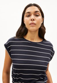 Navy T-shirt with white horizontal stripes, round neckline, rolled short sleeves, soft cotton fabric, casual fit, minimalistic design.