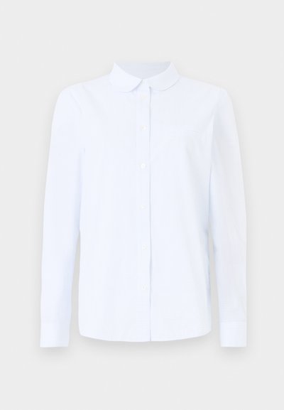 Camicia a maniche lunghe di colore blu chiaro, realizzata in un mix di cotone testurizzato, con colletto a punta, chiusura con bottoni e taschino sul petto.