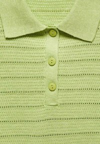 Světlé zelené pletené polo tričko s texturovaným vzorem, límečkem a čtyřmi odpovídajícími knoflíky na légě.