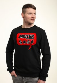 Schwarzer Sweatshirt mit einem roten Sprechblasen-Design, auf dem das Wort "MISTER" sowie verschiedene Symbole in Weiß und Schwarz abgebildet sind. Weiche Textur, lässige Passform.