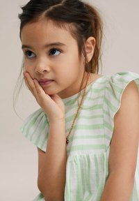 Light green and white striped dress with ruffled sleeves, featuring gathered texture at the hem. A red necklace is partially visible.