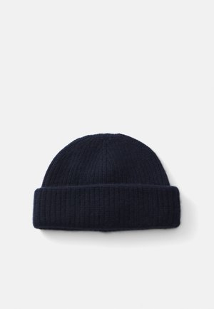 Marine strikket hue lavet af blødt stof, med ribbet tekstur og en foldet kant nederst. Glat og tætsiddende design.