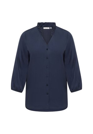 Blouse bleu marine en tissu lisse, avec un col volanté, une fermeture à boutons sur le devant et des manches trois-quarts avec des poignets élastiques.