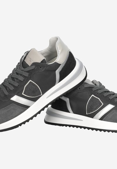 Black and gray sporty sneakers with white soles, lace-up design, and reflective silver accents, stacked against a white background.