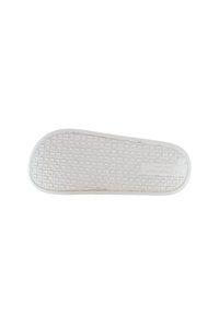 Vitt gummisul av en U.S. Polo Assn. sko med ett våffelmönster, sett från botten isolerat på vit bakgrund.